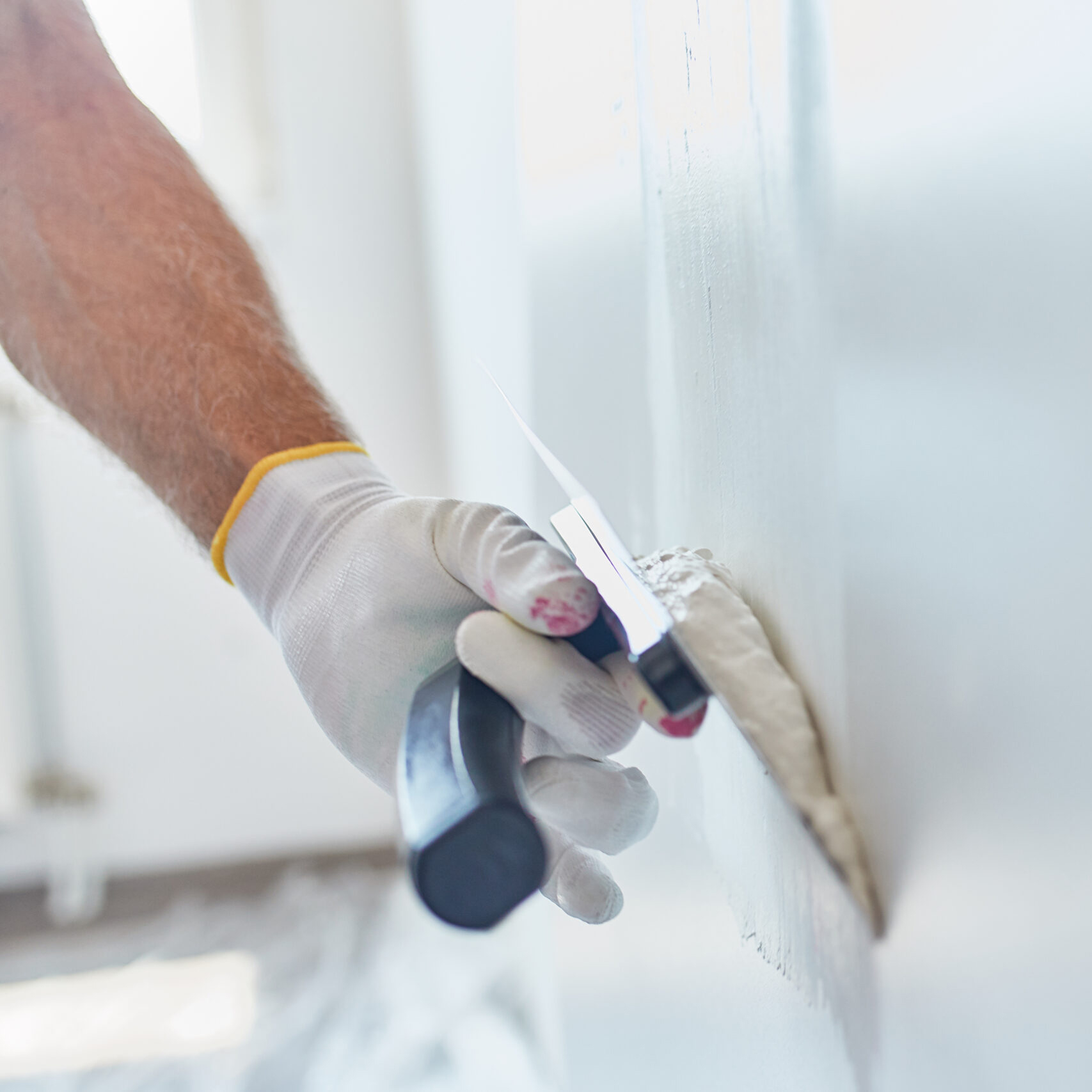 Man Repairing The Wall With Trowel